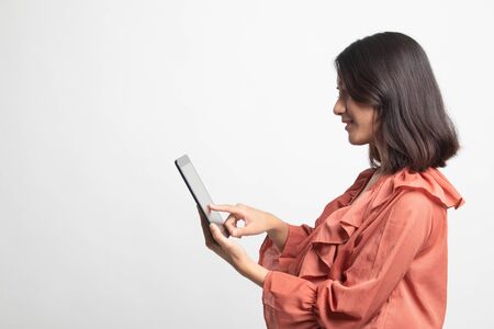 Young Asian woman with a computer tablet on white backgroundの写真素材