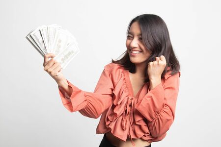 Portrait of  young asian woman  showing bunch of money banknotes on white backgroundの写真素材