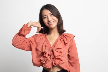 Young Asian woman show with phone gesture on white backgroundの写真素材
