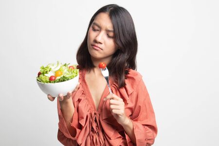 Asian woman hate salad on white backgroundの写真素材