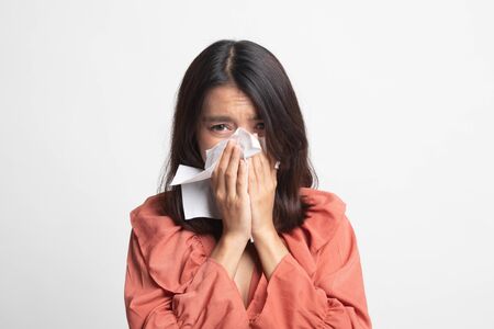 Young Asian woman got sick and flu on white backgroundの写真素材