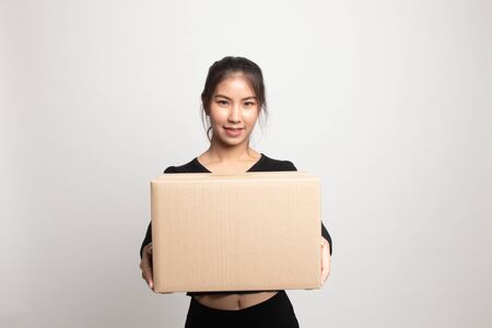 Delivery, relocation and unpacking.  young asian woman holding cardboard box on white backgroundの写真素材