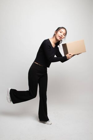 Delivery, relocation and unpacking.  young asian woman holding cardboard box on white backgroundの写真素材