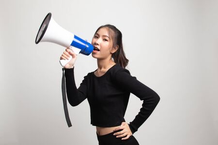 Beautiful young Asian woman announce with megaphone on white backgroundの写真素材