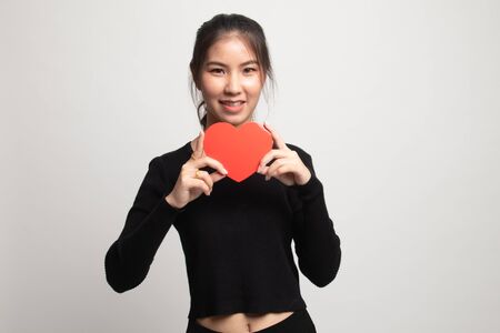 Asian woman with red heart on white backgroundの写真素材
