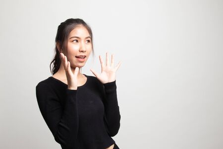 Young Asian woman is surprised and smile on white backgroundの写真素材