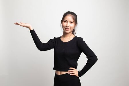Young Asian woman present with her hand on white backgroundの写真素材