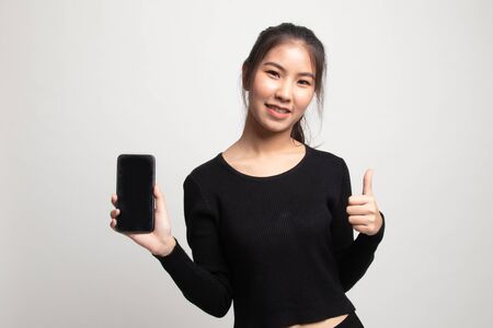 Young Asian woman show thumb up  with mobile phone on white background