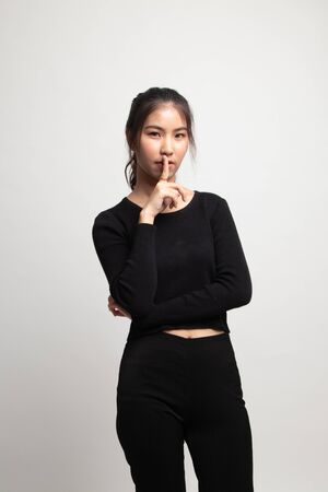 Asian girl smile show quite hand sign on white backgroundの写真素材