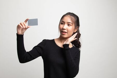 Young Asian woman happy with  blank card on white backgroundの写真素材