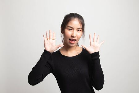 Young Asian woman sticking her  tongue out on white backgroundの写真素材