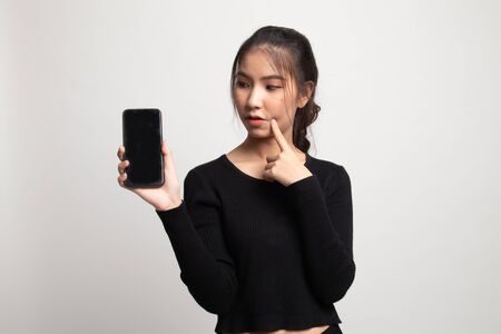 Young Asian woman with mobile phone on white backgroundの写真素材
