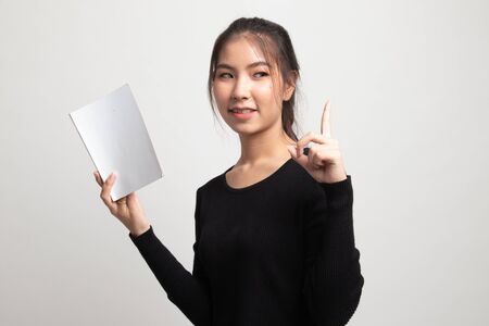 Young Asian woman with a book have an idea on white backgroundの写真素材