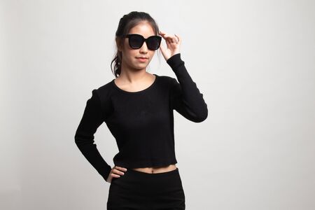 Portrait of a beautiful young asian girl in sunglasses on white backgroundの写真素材