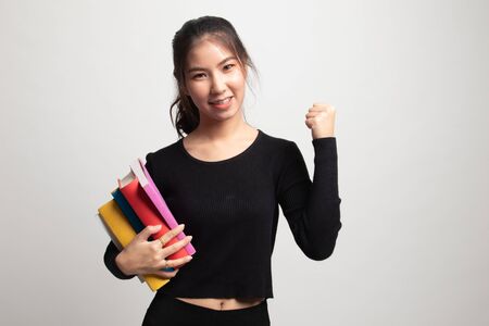 Young Asian woman studying  with may books on white backgroundの写真素材