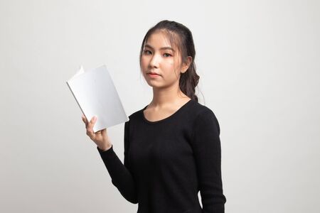 Young Asian woman read a book on white backgroundの写真素材