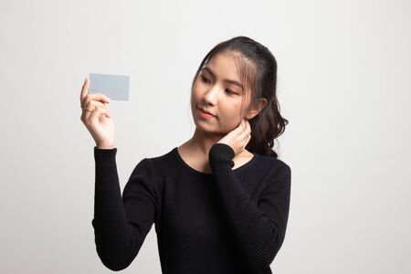 Happy young Asian woman with a blank card on white backgroundの写真素材