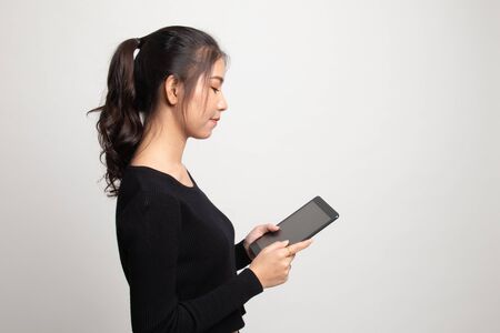 Young Asian woman with a computer tablet on white backgroundの写真素材