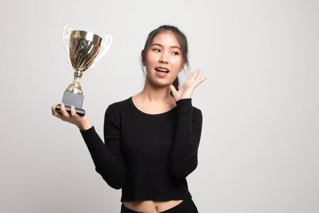 Successful young asian woman holding a trophy on white backgroundの写真素材