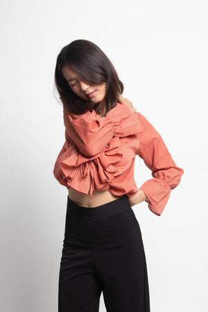 Young Asian woman got back pain on white backgroundの写真素材