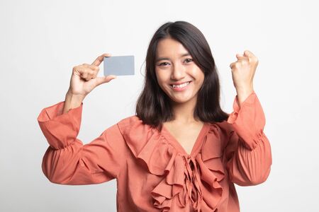 Young Asian woman fist pump with blank card on white backgroundの写真素材