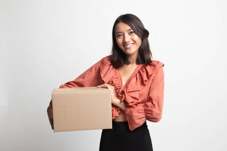 Delivery, relocation and unpacking.  young asian woman holding cardboard box on white backgroundの写真素材