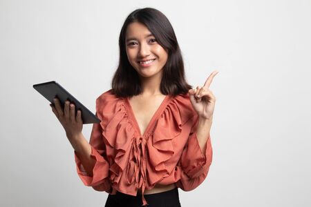 Young Asian woman with a computer tablet on white backgroundの写真素材