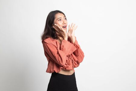 Beautiful young Asian woman shocked  and look up on white backgroundの写真素材