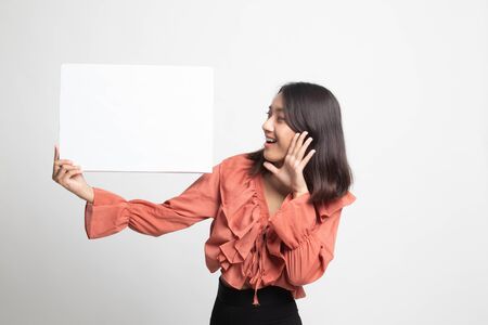 Young Asian woman  surprise with  white blank sign on white backgroundの写真素材