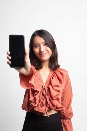 Young Asian woman with mobile phone on white backgroundの写真素材