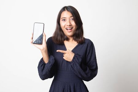 Excited Young Asian woman point to mobile phone on white backgroundの写真素材