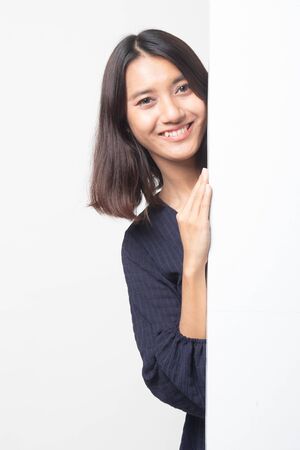 Young Asian woman with blank sign on white backgroundの写真素材