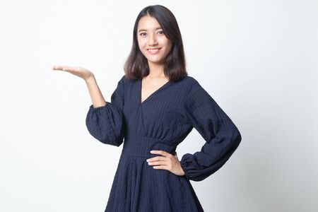 Young Asian woman present with her hand on white backgroundの写真素材
