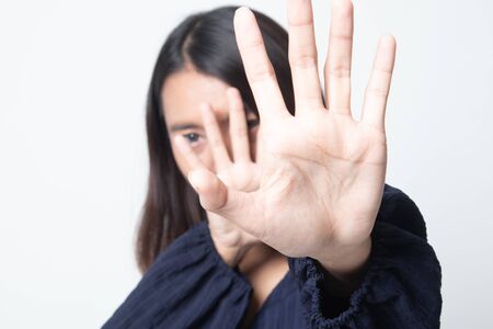 Young Asian woman hide her  face on white backgroundの写真素材