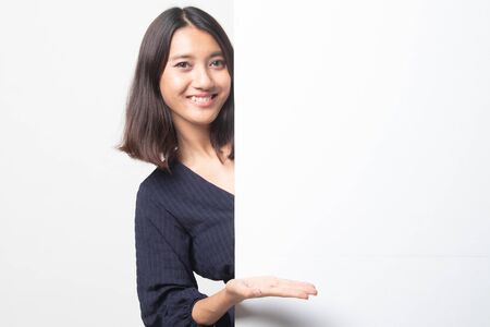 Young Asian woman present blank sign with palm hand on white backgroundの写真素材