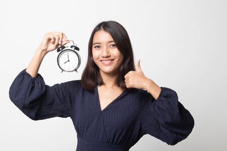 Young Asian woman show OK with a clock on white backgroundの写真素材