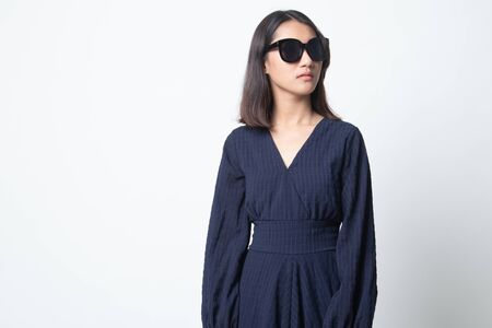Portrait of a beautiful young asian girl in sunglasses on white backgroundの写真素材