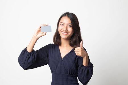 Young Asian woman thumbs up with a blank card on white backgroundの写真素材
