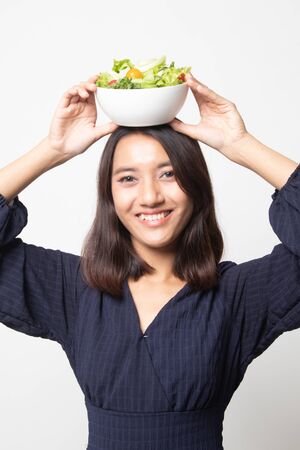 Healthy Asian woman with salad on white backgroundの写真素材