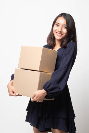 Delivery, relocation and unpacking.  young asian woman holding cardboard box on white backgroundの写真素材