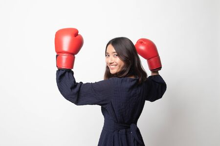 Young Asian woman with red boxing gloves on white backgroundの写真素材