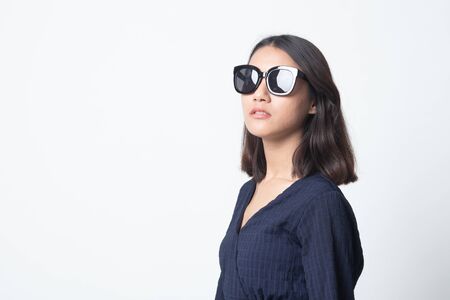 Portrait of a beautiful young asian girl in sunglasses on white backgroundの写真素材