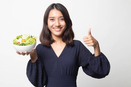 Healthy Asian woman thumbs up with salad on white backgroundの写真素材