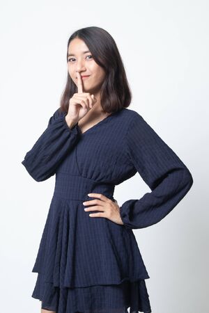 Asian girl show quite hand sign on white backgroundの写真素材