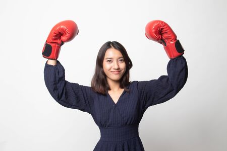 Young Asian woman with red boxing gloves on white backgroundの写真素材