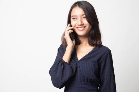 Young Asian woman talking with mobile phone on white backgroundの写真素材