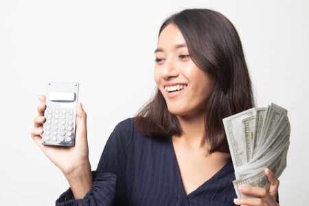 Portrait of  young asian woman  showing bunch of money banknotes on white backgroundの写真素材