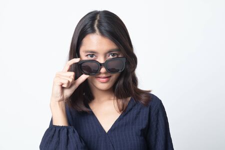 Portrait of a beautiful young asian girl in sunglasses on white backgroundの写真素材