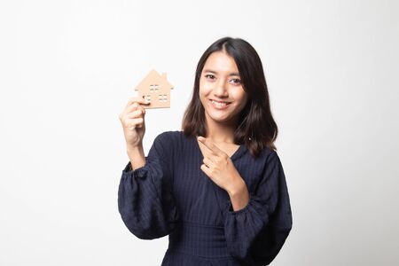 Happy young asian woman with house model on white backgroundの写真素材