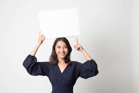 Young Asian woman point to blank sign on white backgroundの写真素材